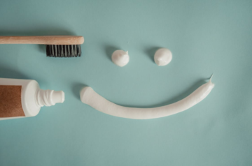 https://www.pexels.com/photo/toothbrush-a-a-tube-of-toothpaste-and-a-smile-painted-with-toothpaste-15694640/